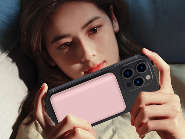 Pink and black smartphone case with dual camera cutout, being held to demonstrate photography position.