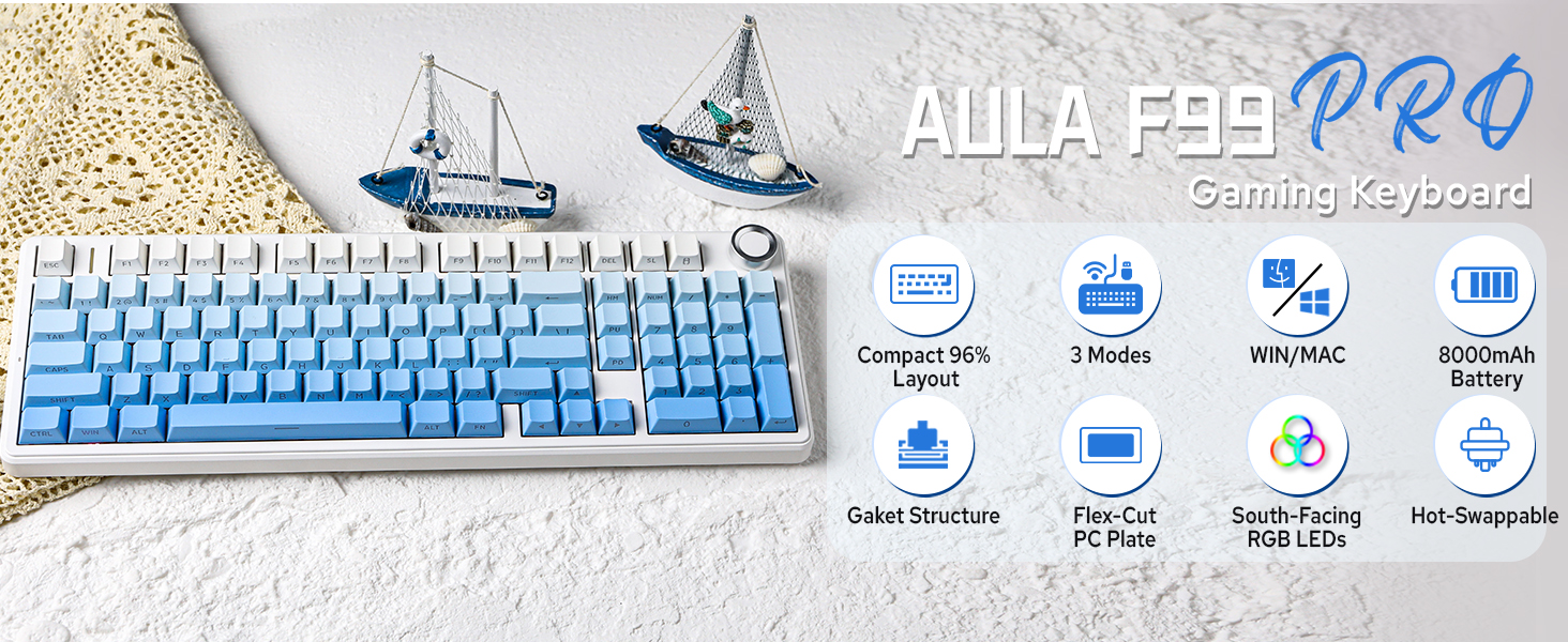 Text reads "AULA F98 PRO" with product icons below showing "Gateron Switches", "Pixel Art", "Specs Typing", and "Hot Swappable". Blue and white mechanical keyboard displayed with decorative ship elements on white background.