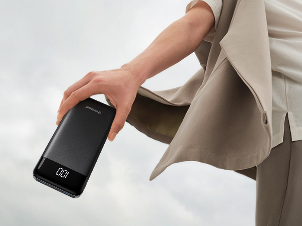 a person holding a samsung galaxy note 8 smartphone in a grey coat.