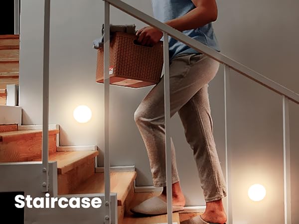 a person carrying a suitcase down the stairs.
