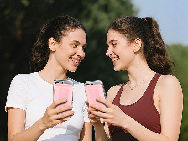 Group of young people in casual attire smiling and interacting in a natural outdoor setting with trees in background.