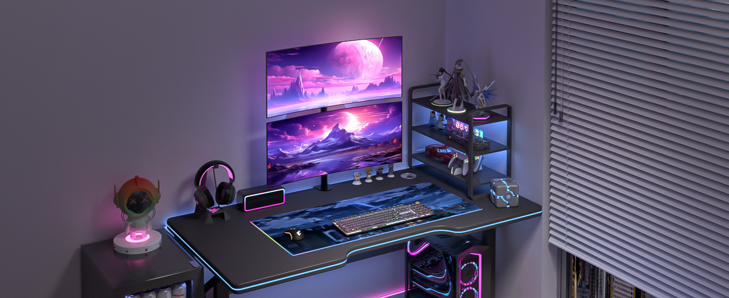 Gaming setup featuring LED-lit desk with purple-themed monitor displaying cosmic scenery, gaming peripherals, and organized shelf unit.