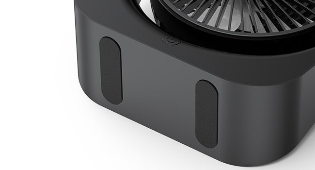 Close-up of a black electronic device base with vents and a circular fan visible on top.