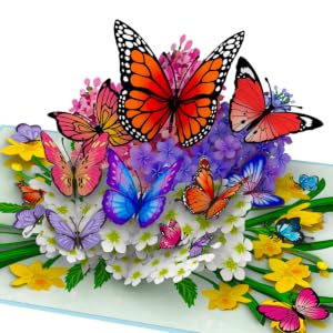 Colorful 3D pop-up card featuring multiple butterflies in various colors and sizes, surrounded by flowers and foliage. Vibrant orange, blue, and purple hues dominate.