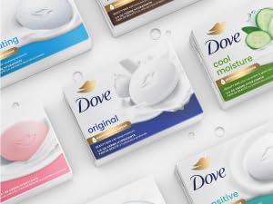 Picture of various Dove cleansing bars packaging against a white background with clear droplets. 