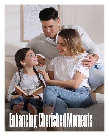 A brightly lit room with a family of three reading together.