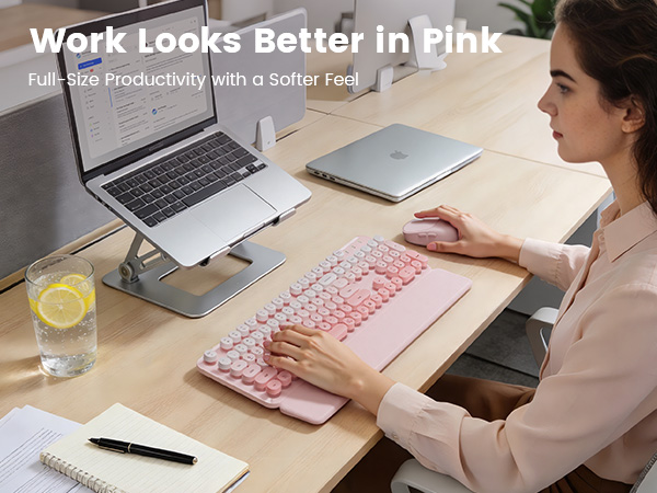 Pink wireless keyboard mouse combo on desk with laptop stand wrist rest for daily work
