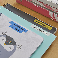 Filing folder labeled with plastic tapes