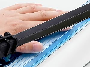 Safety guard: Close-up of safety guard on paper cutter for added protection during use