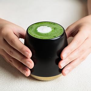 holding iced matcha tea