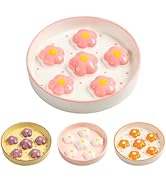 Circular ceramic dish with six pink flower-shaped indentations. Three smaller dishes below show similar designs in purple, white, and orange flower patterns.