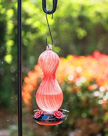 Red glass hummingbird feeder for outdoors