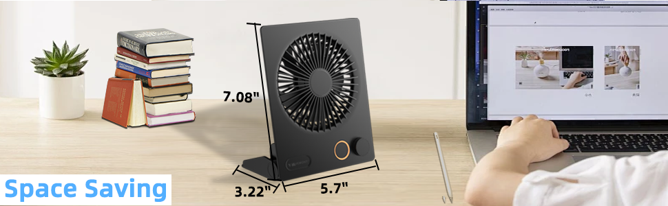Compact black desk fan shown with dimensional measurements of 5.7 inches width and 7.85 inches height, displayed alongside laptop and books.