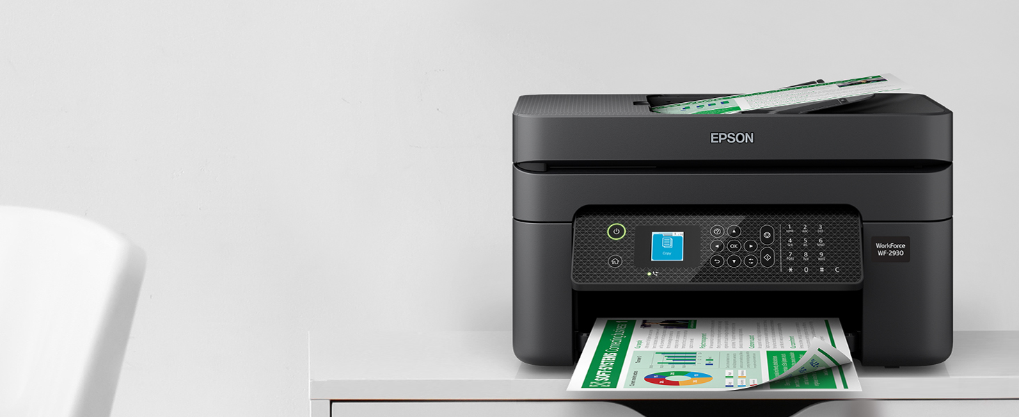 Black WorkForce WF-2930 sitting on cabinet with prints in output tray.