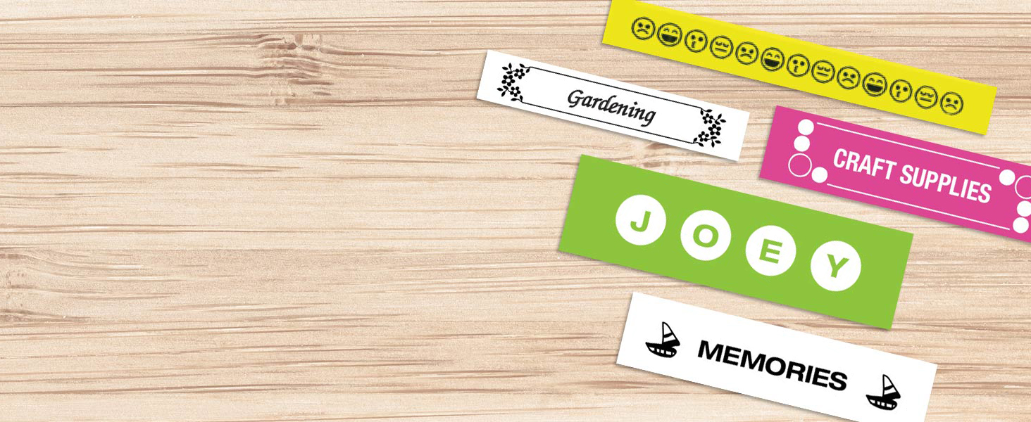 Different colored sample labels on a wood surface, with different fonts, symbols, and borders used