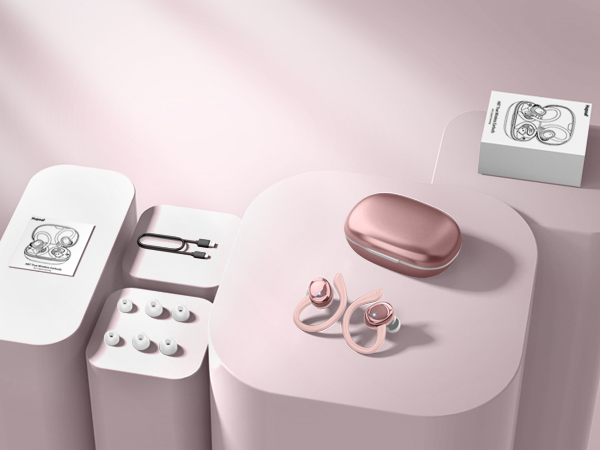 Rose gold wireless earbuds with charging case on pink surface. Packaging, pills, and paper clip nearby. Earbuds feature stem design and in-ear fit.