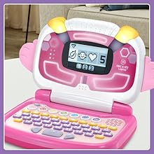 Toy laptop sits on living room table. Screen displays quick coding game.