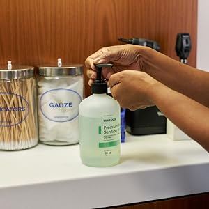 A nurse sanitizing hands with McKesson Premium Hand Sanitizer