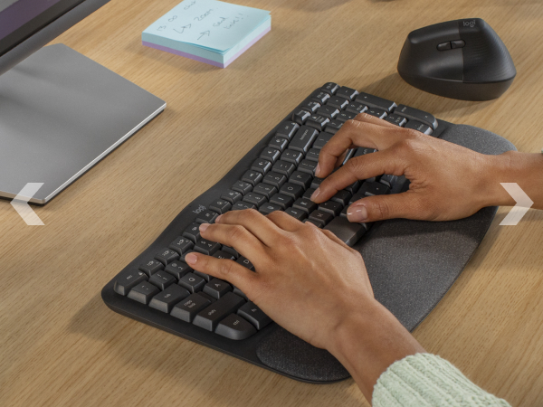 a woman typing on wave keys wireless ergonomic keyboard with a cushioned palm rest