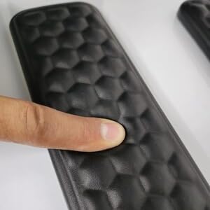 finger pressing nicwe wrist rest black slow rebound memory foam texture close up,high-density pad