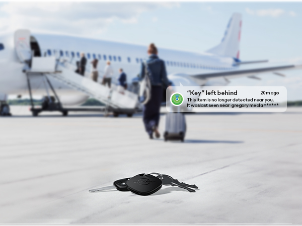 Car keys on tarmac near airplane boarding stairs. Passengers walking to plane in background. Message bubble about keys left behind visible.