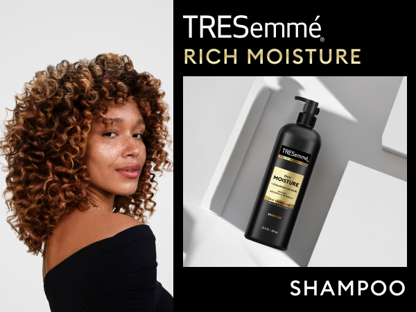 Model with bouncy curls beside TRESemmé Shampoo on top of a geometrical, sleek surface.