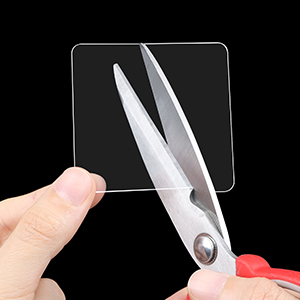 A scissors is cutting a sticky pad,it's cuttable