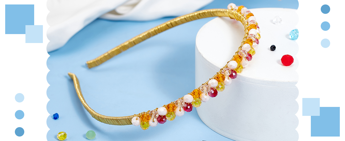 Gold-toned headband decorated with alternating red and clear crystal embellishments in an elegant pattern.