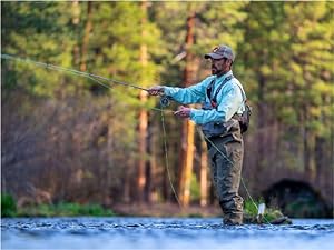 Photo of fisherman casting a fishing line into a river