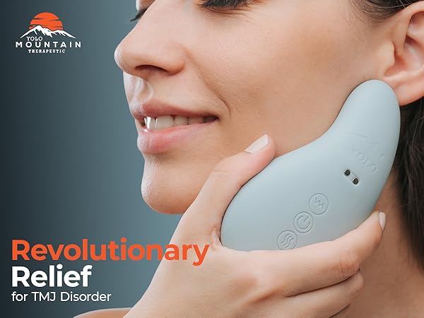 person holding the head massager up to their face