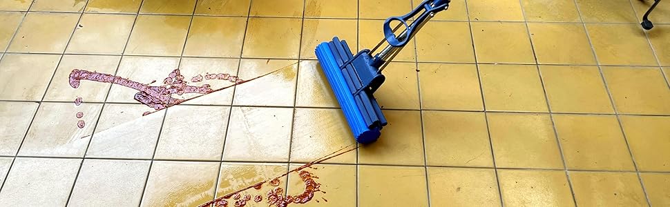 Blue mop cleaning red stains on yellow tiled floor, demonstrating effectiveness in removing spills or messes.