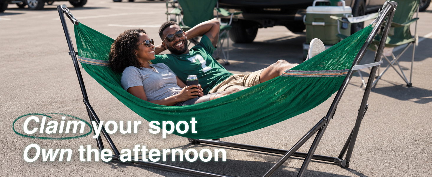 Couple relaxing with drinks in a freestanding hammock at a sunny tailgate party, no trees needed.