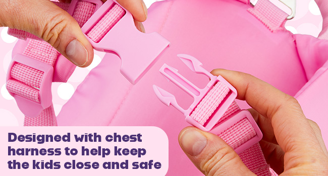 Closeup of hands adjusting a pink chest harness buckle on a child safety device. Text highlights its design for keeping children secure.