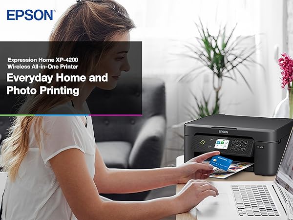 Person shopping online with Expression Home XP-4200 printer sitting on desk in the background. 