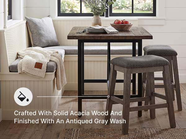 Close-up of the barstool seat highlighting textured gray polyester fabric and nailhead trim