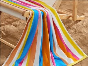 a towel with a thinner multi-stripe design, laying over a wooden beach chair
