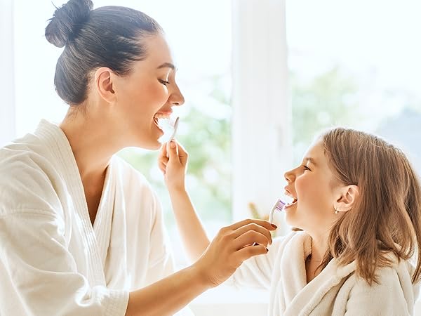 mom and daughter brushing teeth
