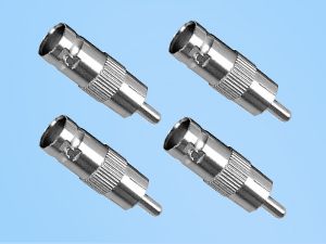 Four identical silver metal connectors with ridged bodies and smooth ends. Each connector has a protruding pin on one end and appears to be a type of coaxial or audio/video adapter.