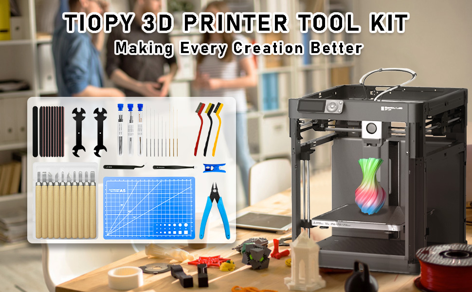 3D printer tool kit labeled 'TOPY' with various accessories including pliers, tweezers, cleaning tools, and a 3D printer in the background.