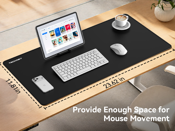 Text reads 'Provide Enough Space for Mouse Movement'. Black desk pad with laptop, keyboard, mouse, and coffee cup on wooden desk surface, demonstrating large work surface area.