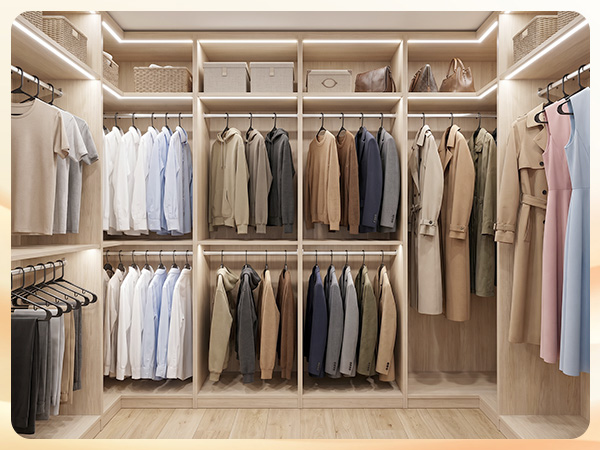 Walk-in closet organized with 50 black plastic hangers. Matching hangers create calm, boutique feel
