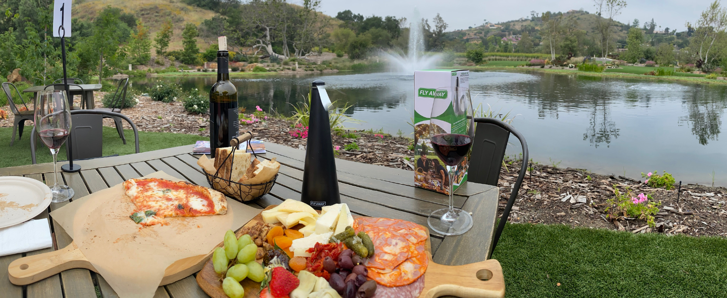 Fly Away fan working on an outdoor dinner table to keep flies away without chemicals.