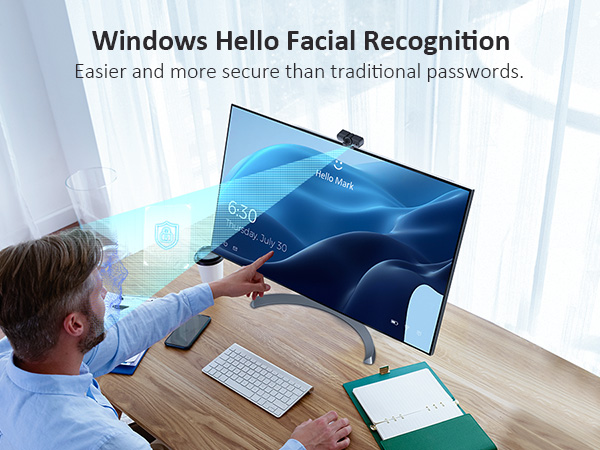 A man is using Windows Hello facial recognition to unlock his computer.