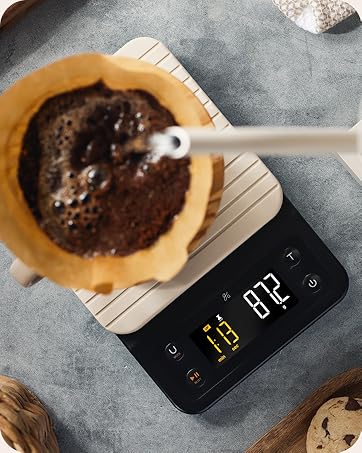 Kettle pouring water to make coffee on scale