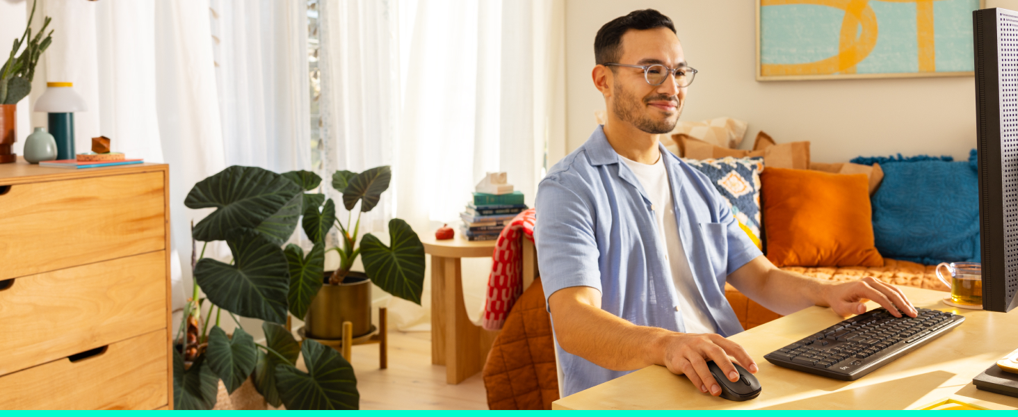 a man using mk295 wireless keyboard and mouse combo