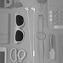 WHITE Panasonic RP-TCM125 wired earbuds flat-laid next to a watch, sunglasses, sissors, calculator