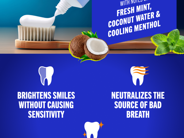 Fluoride toothpaste gel being squeezed onto a toothbrush with mint and coconut denoting freshness