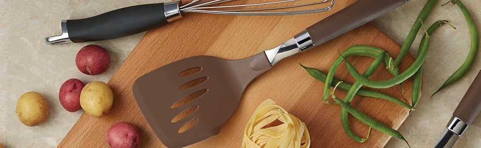 Kitchen utensils and vegetables on a slab