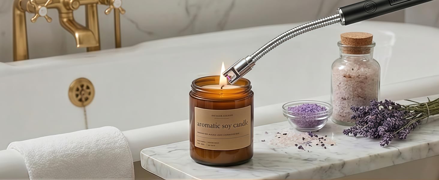 Electric candle lighter safely lighting an aromatic soy candle beside a bathtub in a warm bathroom.
