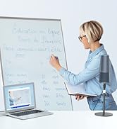 Person writing on a whiteboard in an office setting. A laptop is open on a desk nearby. A microphone on a stand is visible in the foreground.